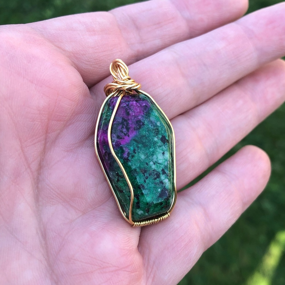 Gold plated wire wrapped coffin shape pendant in ruby zoisite stone.